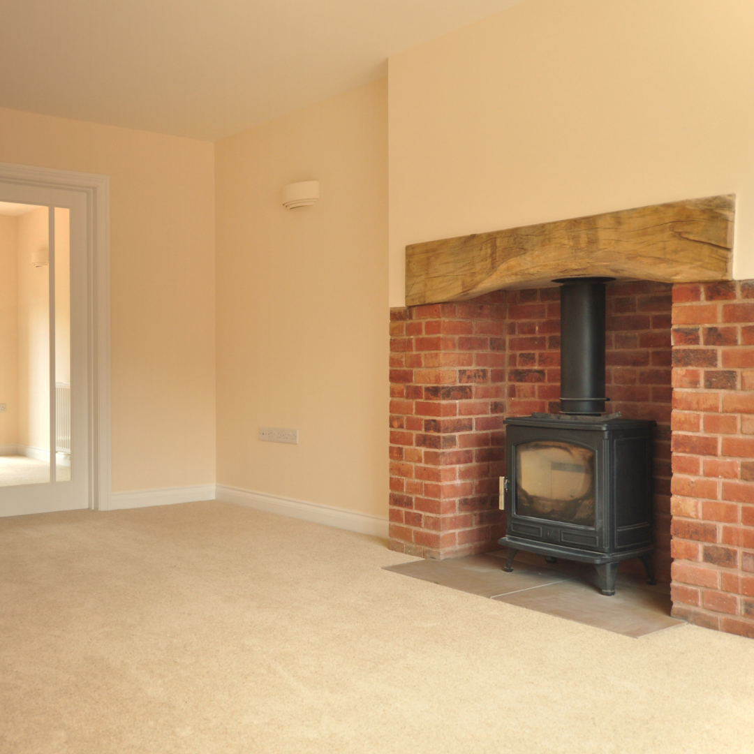 An interior photograph showing the updated fire place with wood burner