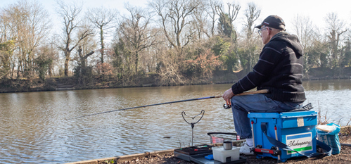 Picture of a man fishing at a pool