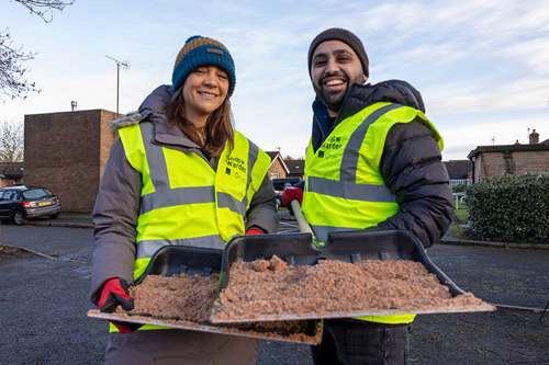 Picture of two happy snow wardens volunteering to help their community in the winter.
