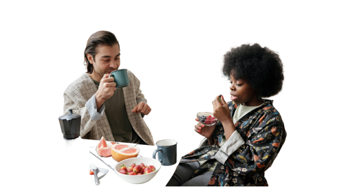 Two people drinking coffee and eating fruit