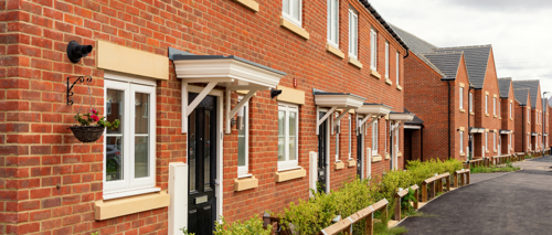 An exterior photo showing the doors and windows of a new build terrace house