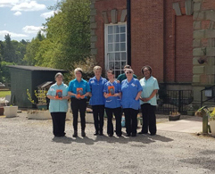 Picture of workers holding kindles outside of a care home