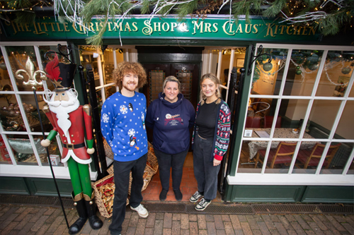 A photo showing the owner and employees in front the of the Little Christmas Shop in Ironbridge