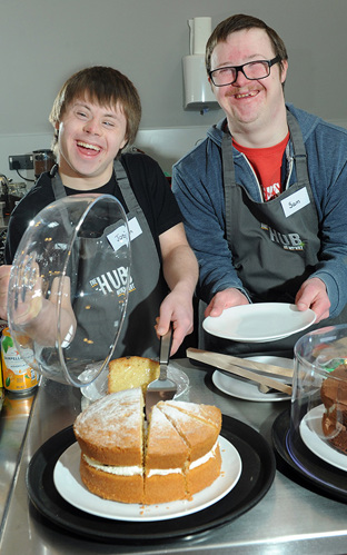 Two people baking a cake