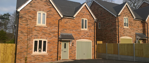 An exterior photograph of a new build detached house