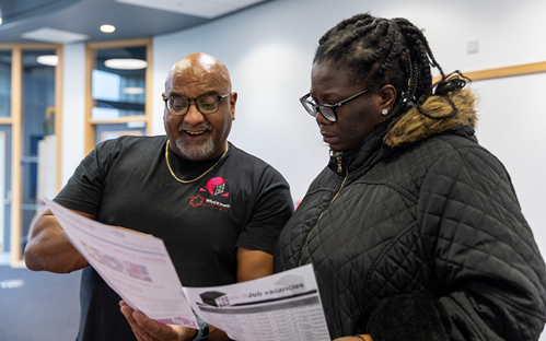 Picture of a Job Box Officer helping a member of the public with finding employment
