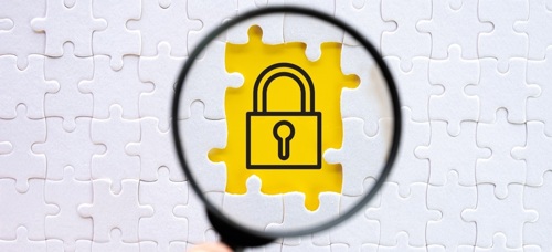 A jigsaw puzzle with pieces removed to show a padlock icon