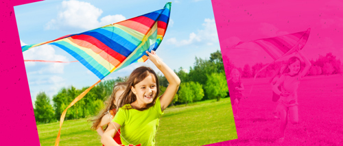 A photograph of a child holding a kite.