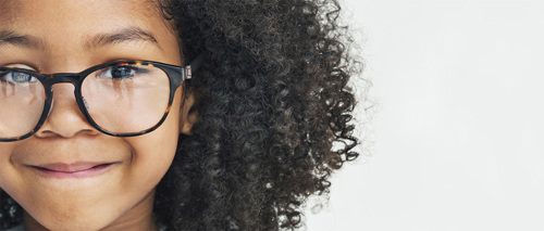 A photo of a girl in glasses smiling