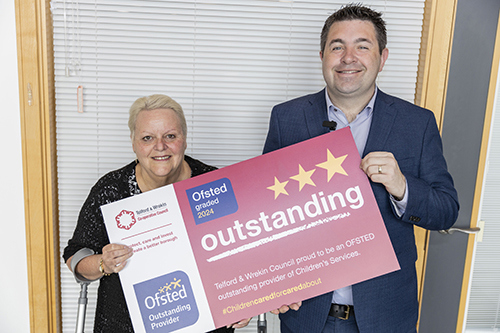 Picture of the Cabinet holding a certificate showing the outstanding inspection from Ofsted 2024