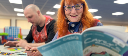 Photo of lady holding the Carers Guide