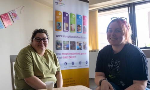 Tow females discussing Learning Disabilities Partnership Board