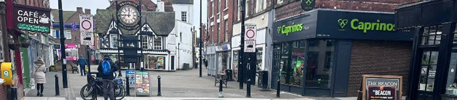 A picture of Wellington town centre with people in shopping.