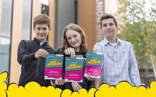 A picture of three young people standing together holding a young person's year of wellbeing leaflet at meeting point house in Telford