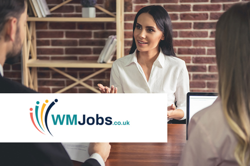 Picture of a female employee in suit and smiling during the job interview.