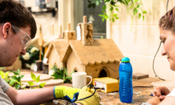 Two people in a workshop working on a wood project