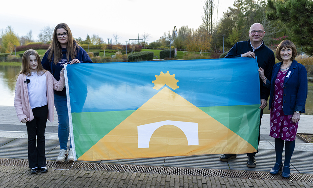 A picture of Ameila from Telford with the flag that she designed for I Love Telford.