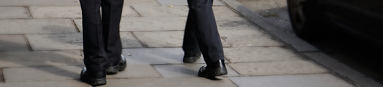 Illustration of two police officers legs patrolling a street
