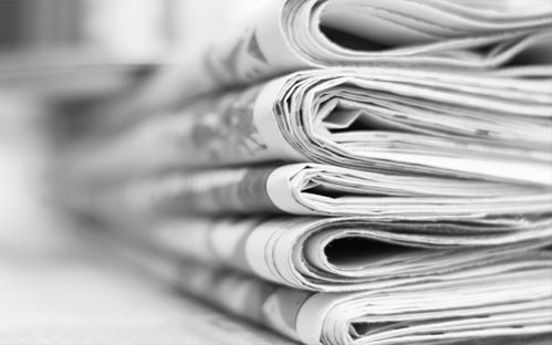 Image of a stack of newspapers.