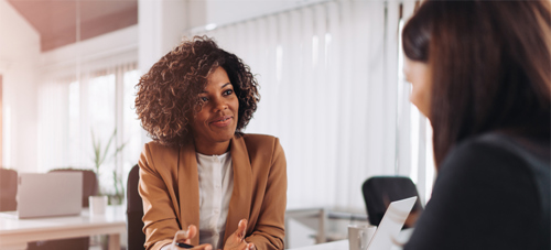 Image of two women having a meeting.