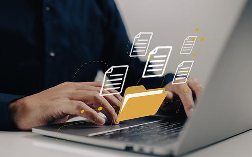 A picture of a man using a laptop with an illustration of an open file folder with flying blank documents with laptop computer