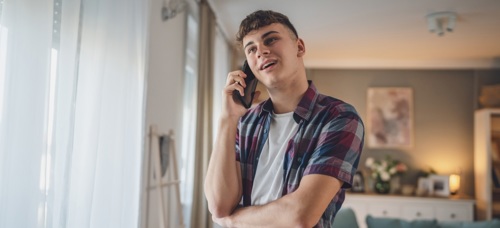 A teenage boy speaking to someone on a mobile phone